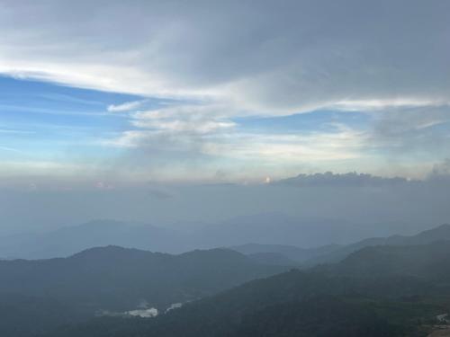 a view of a foggy valley with mountains in the background at QUINCE HOME GRAND ION DELEMEN GENTING HIGHLANDs in Genting Highlands