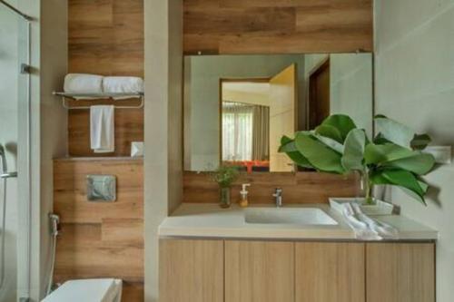 a bathroom with a sink and a mirror at sohonos · Luxurious 3bhk villa in Candolim in Goa