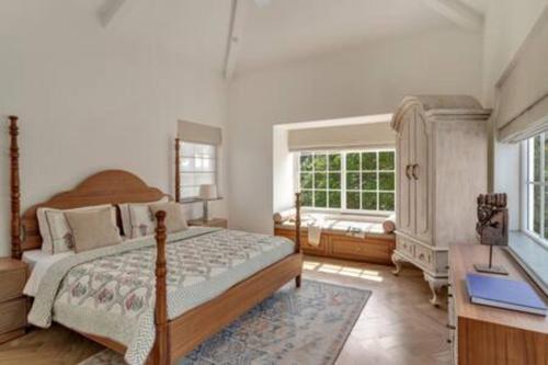 a bedroom with a large bed and a window at Amananjuna 2 · Luxurious 5bhk villa in Anjuna in Goa