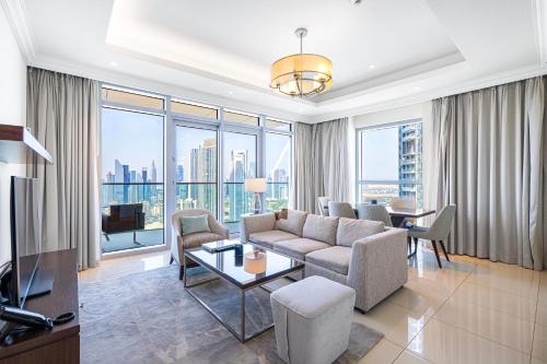 a living room with a couch and a table at The Address Fountain Views - Residence 2 Bedroom with Burj Khalifa view in Dubai