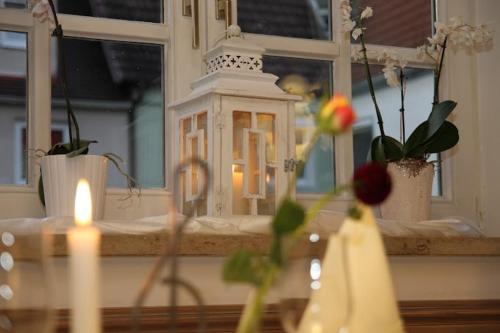 明德爾海姆的住宿－Hotel und Gasthof Zur Laute，窗前的蜡烛和鲜花