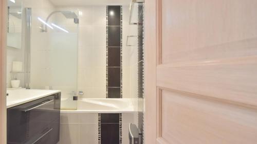 a bathroom with a shower door and a sink at LE 5 CROISETTE OR in Cannes