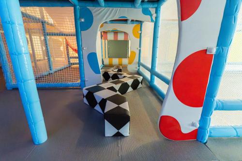 a play room with a snowboard on a slide at Guide Hotel Kaohsiung Liuhe in Kaohsiung
