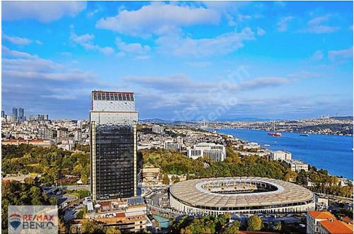 a view of a city with a building and a stadium at Kiralık Daire - Ritz Carlton Residance Süzer Plaza'da Eşyalı Manzaralı in Istanbul