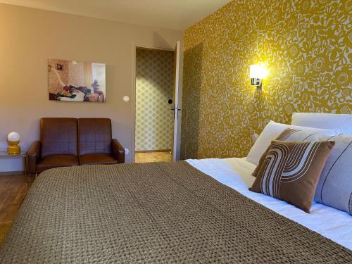 une chambre avec un grand lit et un canapé dans l'établissement Un mouton dans l'eglise, à Putot-en-Bessin