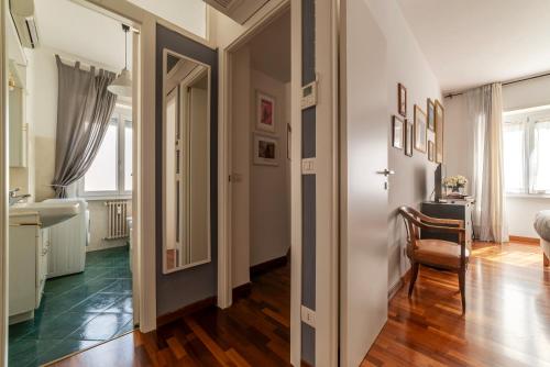 a hallway with a table and a chair in a room at Cipro Apartment with balconies in Rome