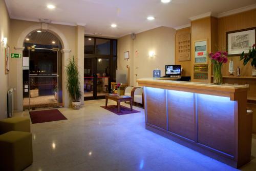 a lobby with a bar in a hospital at Hotel Santa Mafalda in Fátima