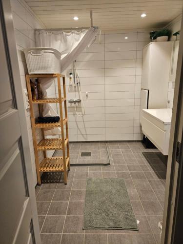 a small bathroom with a sink and a refrigerator at House with a wiew in Lenangsøyra