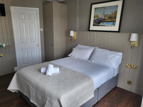 a bedroom with a bed with two towels on it at Urban Nest Townhouse in Galway