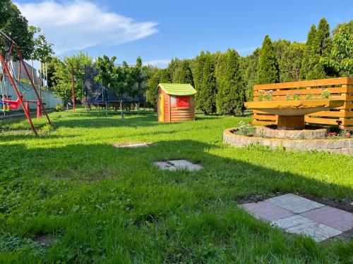 a park with a bench and a playground at Guesthouse & restaurant Tekovina in Smederevo