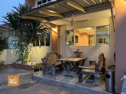 a patio with a wooden table and two chairs at The1place in Khon Kaen