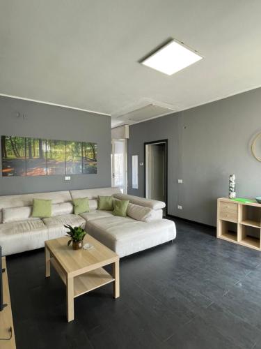 a living room with two white couches and a table at Casa Anna in Predore