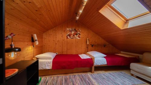 a bedroom with two beds in a attic at Grenko House in Vrata