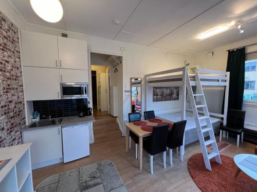 a small apartment with a bunk bed and a kitchen at Central university - centralt högskolan in Halmstad