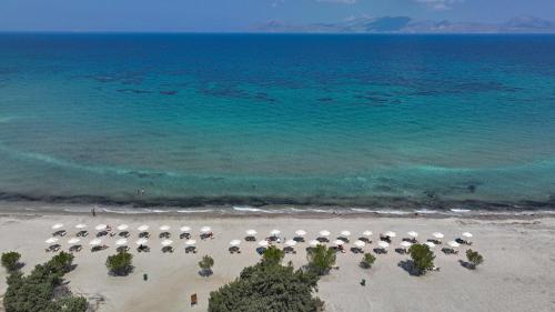 an aerial view of a beach with chairs and umbrellas at Achilleas Beach Hotel Adults Only in Mastichari