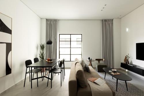 a living room with a couch and a table at Mr. Rothschild by TLV2GO in Tel Aviv