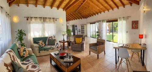 a living room with a couch and a table at casa verde in Lajares