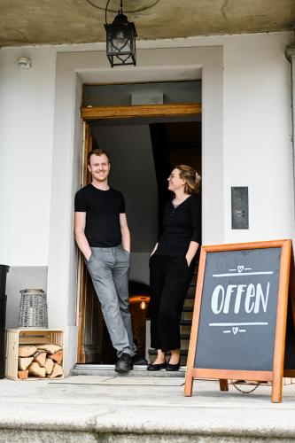 a man and a woman standing in a doorway at Gasthaus zum Bauernhof in Oberlunkhofen
