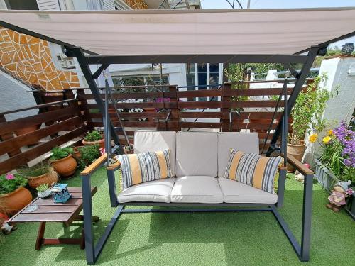 a white couch sitting under a gazebo on a patio at Zoe garden home in Spáta