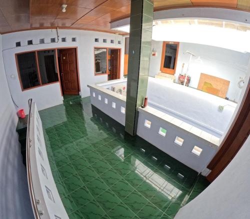 an overhead view of a house with a green floor at Griya Sinduadi Homestay Jogja in Jetis