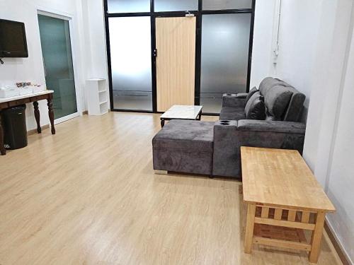a living room with a couch and a coffee table at Pearl Homestay Hat Yai in Hat Yai