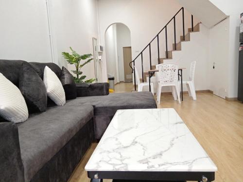 a living room with a couch and a table at Pearl Homestay Hat Yai in Hat Yai