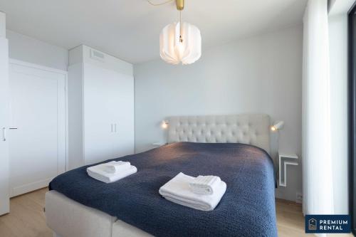 a bedroom with a bed with two towels on it at Premium Duplex Suite I and II floor C09 and C20 in Hanko