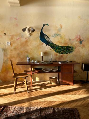 a room with a table and a bird on the wall at Hotel CASA VICO in Ako