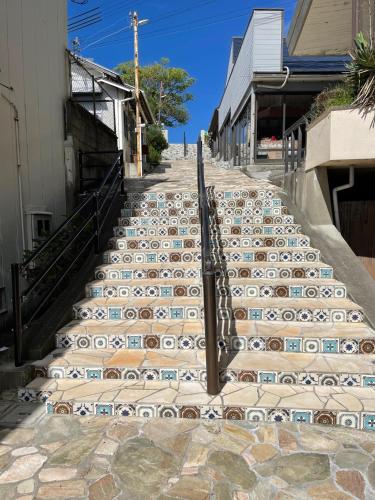a set of stairs with tiles on them at Hotel CASA VICO in Ako