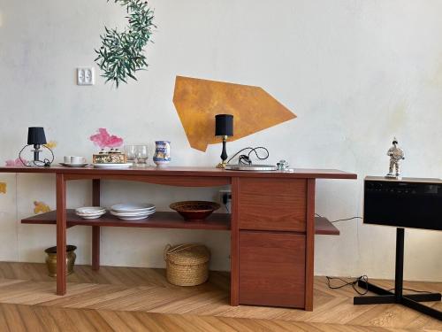 a wooden table in a room with a desk at Hotel CASA VICO in Ako
