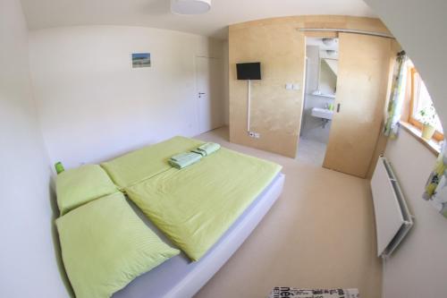 a small room with a bed and a bathroom at Penzion Tsport in Wotitz