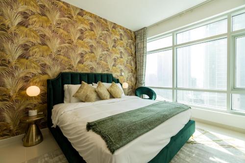 a bedroom with a large bed with a green headboard at Ultimate Stay / 2 Beds / Opera and Fountain views in Dubai