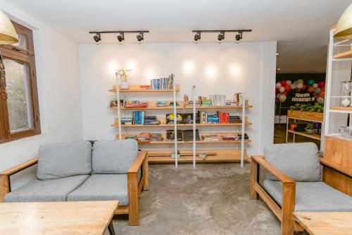 a living room with two couches and bookshelves at Cloud 9 Garden in Kathmandu