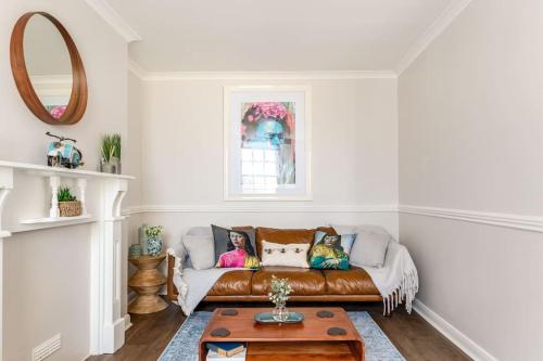 a living room with a couch and a table at Stylish 2Bed 2Bath Seafront Patio Apartment in Brighton & Hove