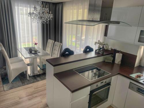 a kitchen and dining room with a table and a dining room at Modern 2 bed house near Bratislava with parking in Rovinka