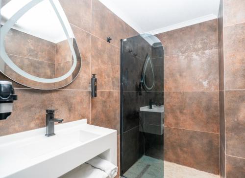a bathroom with a sink and a shower at 216 Style Suite in Istanbul