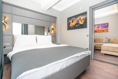 a bedroom with a large bed and a couch at 216 Style Suite in Istanbul