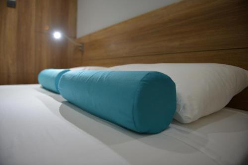 two blue and white pillows on a bed at Pyramos Hotel in Paphos City