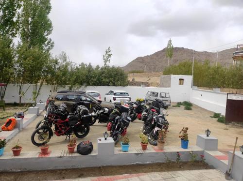 a bunch of motorcycles parked in a parking lot at LADAKH ODYSSEY Hotel in Leh
