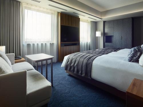 a hotel room with a bed and a couch at Mitsui Garden Hotel Gotanda - Tokyo in Tokyo