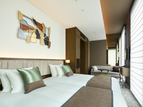 a bedroom with a large white bed in a room at Hotel The Celestine Ginza in Tokyo