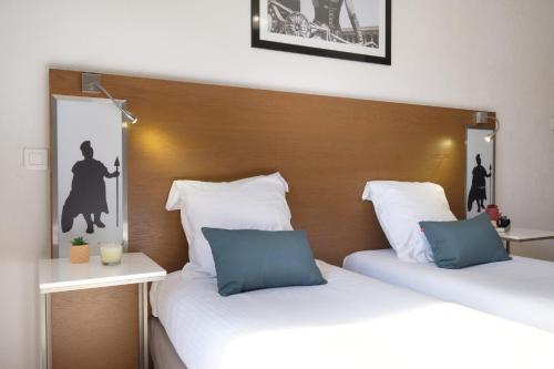 two beds sitting next to each other in a room at Comfort Aparthotel Antibes Le Maestria in Antibes