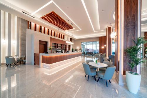 a restaurant with tables and chairs and a bar at Pickalbatros Vita Resort - Portofino Marsa Alam in Abu Dabab