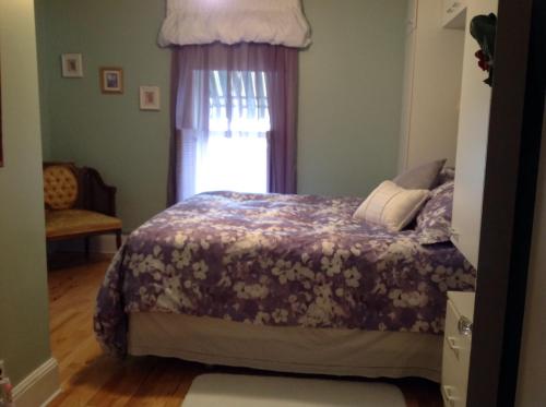 A bed or beds in a room at Maple Tourist Home B&B