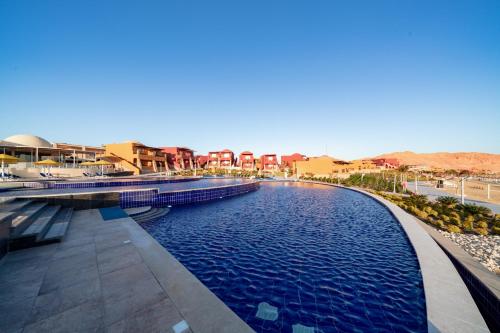 a view of a swimming pool at a resort at Pickalbatros Vita Resort - Portofino Marsa Alam in Abu Dabab