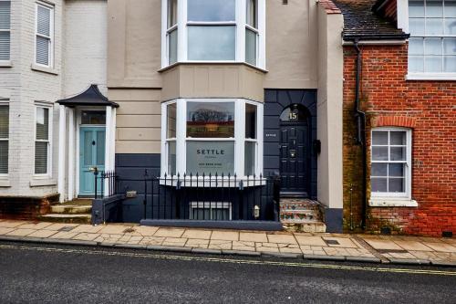 a house with a black door on a street at Settle in Winchester - Stylish Self Check-In Rooms in Winchester