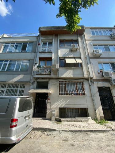 a van parked in front of a building at Bakırköy Selvi Apartmanı in Istanbul