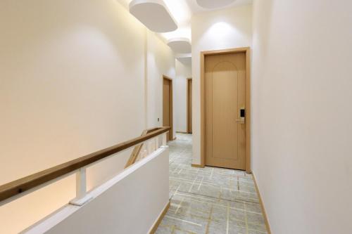 a corridor of an empty room with a door at Casabella Homestay Batam in Nagoya