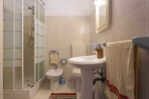 a bathroom with a sink and a toilet and a shower at Mare e relax in Menfi