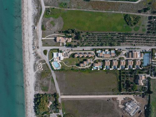 an aerial view of a house complex next to the water at Restia in Almiros Beach